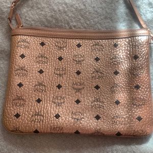 MCM bag. Metallic rose gold. Brand new. Perfect condition. Leather. Clutch